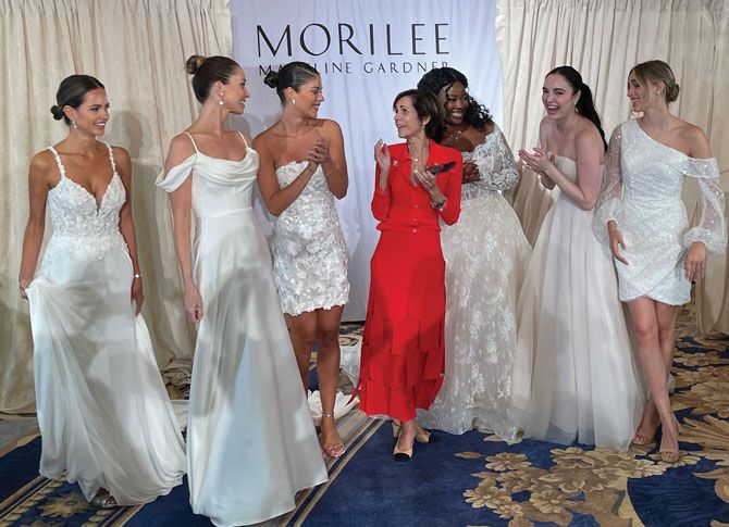 Madeline Gardner celebrates with Morilee models at end of show.