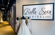 The long hall entrance that leads to the second-floor showroom is lined with notes and photos hanging on the walls from brides over the years. Gowns in photo: Sorella Vita on both ends and Justin Alexander in the middle. Photo ©Shawn Black Photography