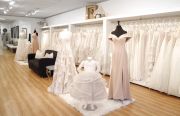 The bridal collection is showcased near a little seating area. A long hallway leads to the bridal fitting area and bridesmaids’ room to the far right.