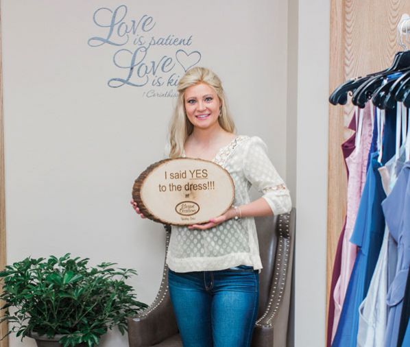 One of the many bible verses displayed throughout the store near an excited bride who found her gown.