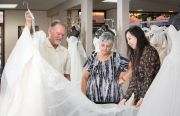 Ferndales Owners Tom and Connie Linnert admire a dress from Estee’ Couture Bridal with Designer/Owner Estee Yao.