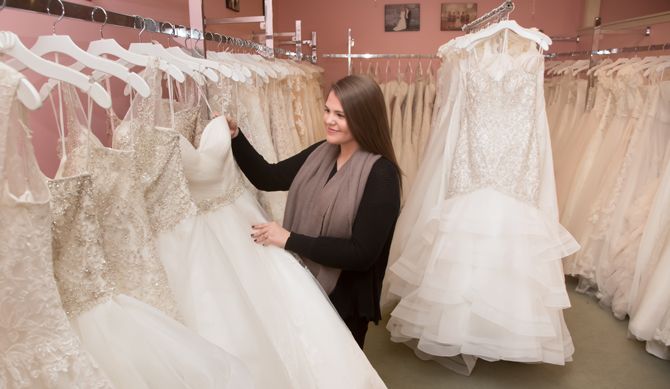 Libby Lawson, assistant manager,
pulling a dress for the bride.