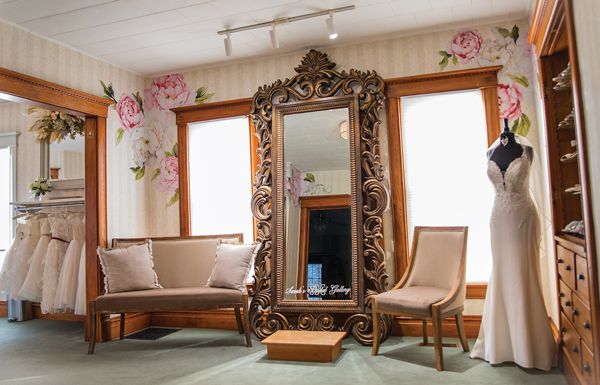 Bridal room #3 includes a bridal mirror platform, flower girl dresses on the left and a shoe case/display on the right.