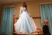 Seamstress Anne Manley works on a prom fitting.