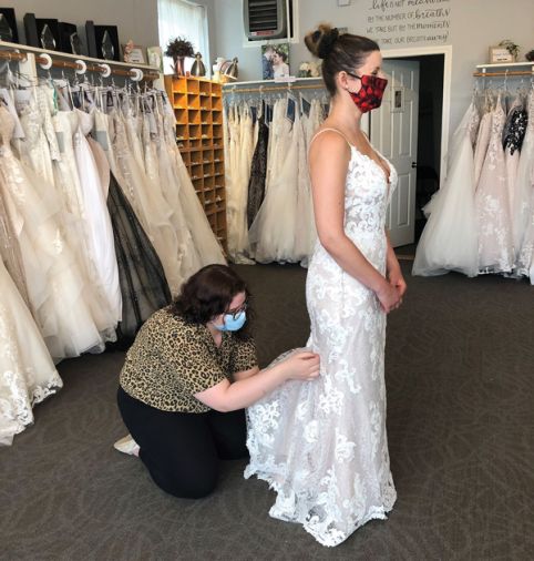 Staff members and brides wearing masks became commonplace this spring. The practice is likely to stick at many bridal shops around the U.S. until a vaccine for COVID-19 becomes readily available. (Courtesy of Country Bridals & Formal Wear)