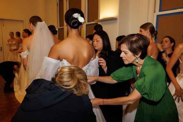 Designer Madeline Gardner preps models pre-runway show.