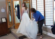 Operations Manager/Master Seamstress Maria Demetriou does a final fitting with a bride.