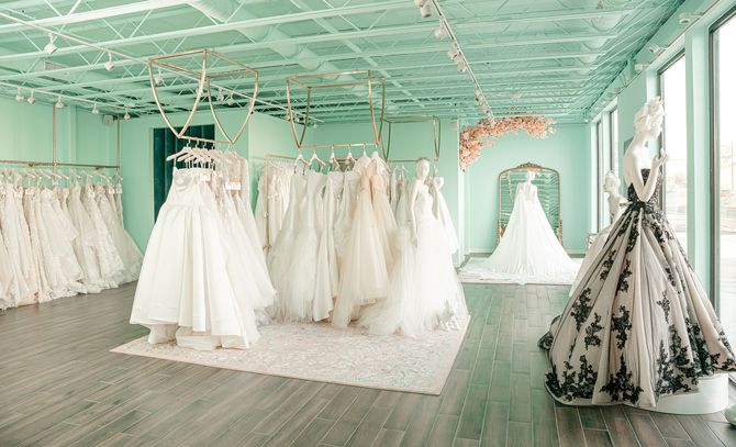 Gowns are hung on the spacious first floor from elegant gold fixtures.