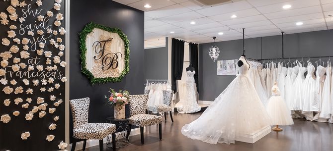 Brides sign wooden flowers with their name and wedding date and put it on the store&rsquo;s &ldquo;Said Yes&rdquo; wall. When they pick up their dress, that flower is handed back to them in a window gift box.