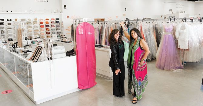 Owners of the building and The Ultimate, Fawn Merlino and Heather Siegel, in the middle of the 10,000-sq-ft store filled with more than 20,000 dresses.