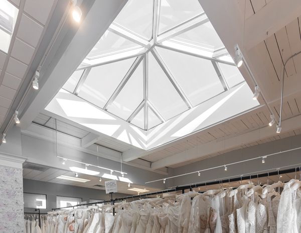 Natural lighting from the ceiling at VOWS Bridal contributes to a bright, spacious feel.
