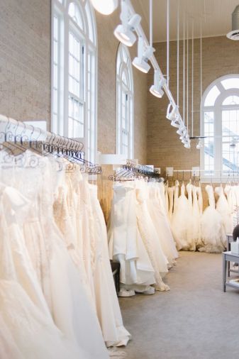 Rack lighting adds to the visual appeal of gowns at Little White Dress Bridal Shop in Denver
