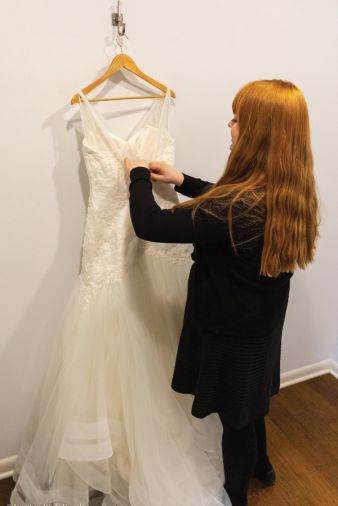 Riley putting up wedding gowns.