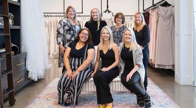 The Bella Bridal Boutique staff (standing, L to R): Lisa Westafer, owner; Hannah Maples, bridal consultant; Julie Walfoort, bridal consultant; Julie Grandprey, bridal consultant. (Sitting, L to R): Angelique Woodruff, bridal consultant; Heather Sward, director of operations; Kirsten Walfoort, sales director.