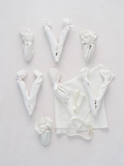 The Sample Size Solution is a kit of clips, bands and fabric designed to enable stores to provide a comfortable fit for brides when trying on gowns too large or too small. The Sample Size Solution is a kit of clips, bands and fabric designed to enable stores to provide a comfortable fit for brides when trying on gowns too large or too small.